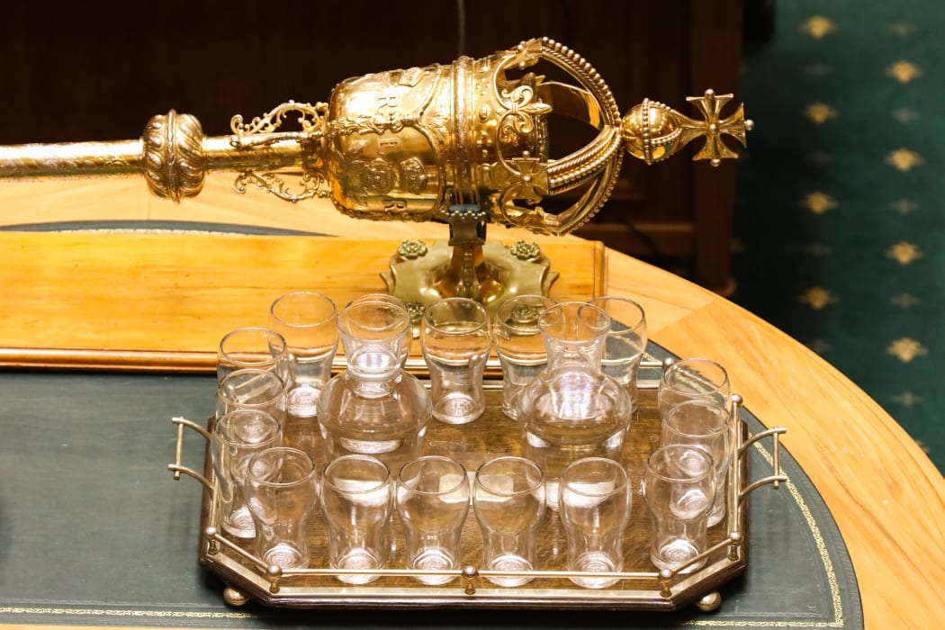 Parliament's Mace sits on The Table next to a tray of water for MPs