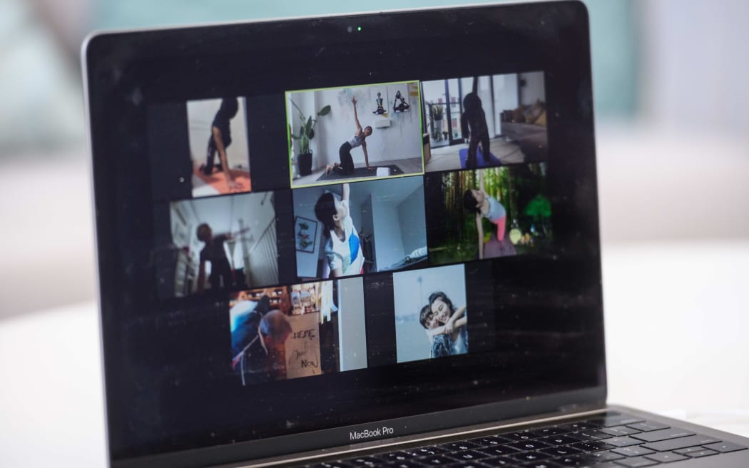 In this picture taken on March 30, 2020, YogaUP founder Chaukei Ngai (top C) is seen leading a group of students via the Zoom online video conferencing platform, during a live streamed yoga class at her studio in Hong Kong.