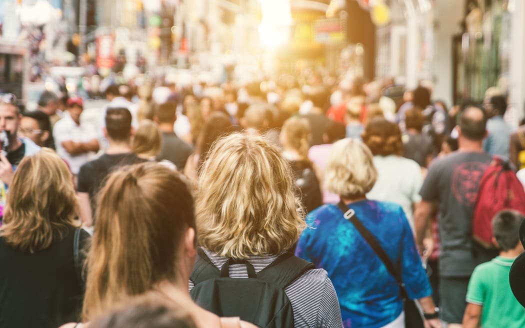 Unrecognizable mass of people walking in the city