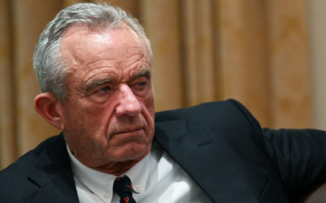 Robert F Kennedy Jr - a 71 year old man with cropped grey hair - wears a suit and looks to the side.