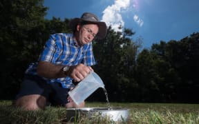 Sam Carrick testing water inflitration into soil