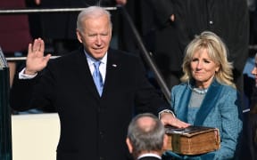 Joe Biden, alongside incoming US First Lady Jill Biden, is sworn in as the 46th US President by Supreme Court Chief Justice John Roberts.