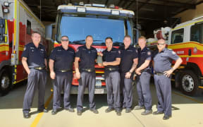 Mount Isa Queensland Fire and Emergency Services firefighters with the returned bell.