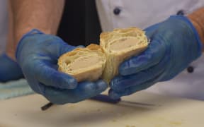 Checking a sausage roll for the Bakels Legendary Sausage Roll Competition.
