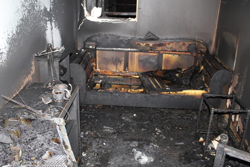 Fire extinguished at 4 minutes, shows a lack of structural damage. Prime contributor to heat, flames, smoke and gases was the polyurethane foam of the sofa.