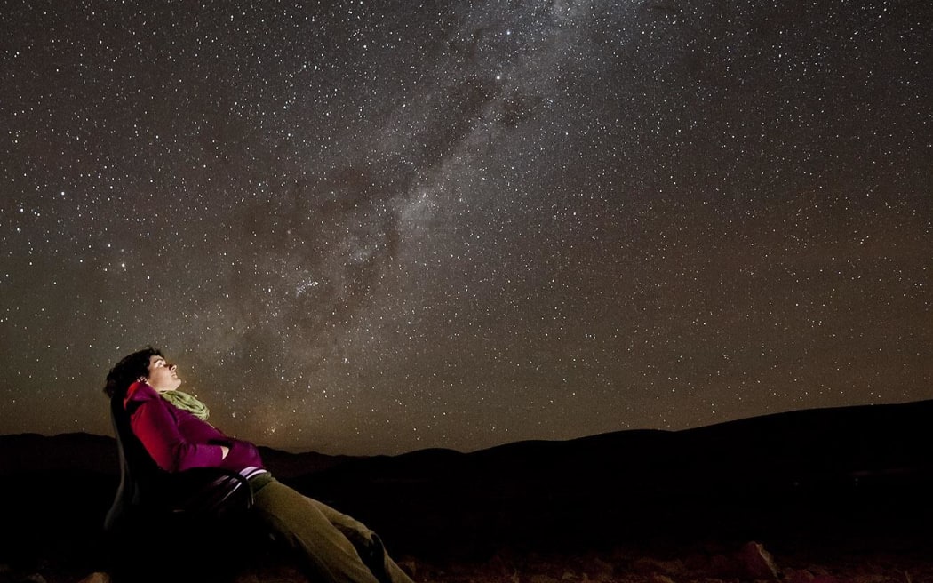 Spanish astronomer Amelia Bayo contemplates the Milky Way in the Atacama Desert, Chile.