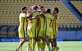 Paulo Retre and Wellington Phoenix team-mates celebrate his goal during their A-League match in Wellington, Dec 28, 2024.
