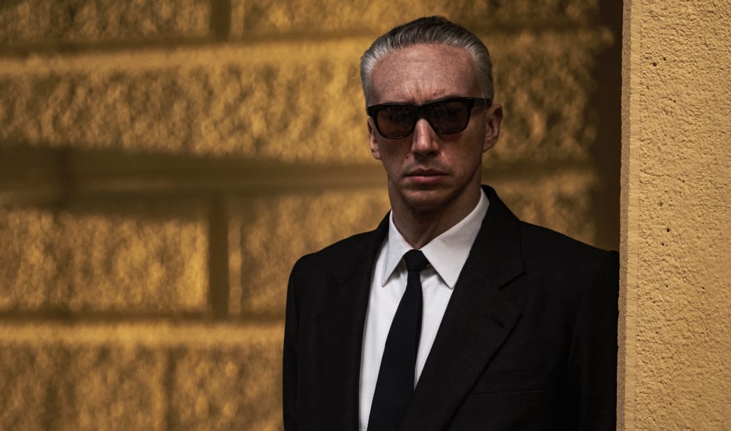 Still from the 2023 Michael Mann biopic Ferrari featuring Adam Driver as Enzo Ferrari.