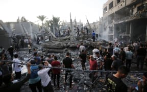 People search for victims and survivors following an Israeli strike on the town of Deir Al-Balah in the central Gaza Strip on October 18 2023. Thousands of people, both Israeli and Palestinians have died since October 7, 2023, after Palestinian Hamas militants based in the Gaza Strip, entered southern Israel in a surprise attack leading Israel to declare war on Hamas in Gaza on October 8. (Photo by Mohammed Faiq / AFP)