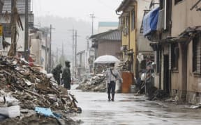 Residents remove debris and conduct a restoration work in Hitoyoshi, Kumamoto Prefecture. The torrential rain that triggered landslides and flooding occurred on July 4th.