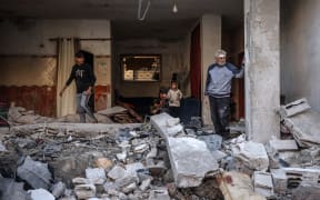 People inspect the damage following Israeli bombardment in Rafah on the southern Gaza Strip on December 29, 2023, amid the ongoing battles between Israel and the Palestinian militant group hamas. (Photo by AFP)