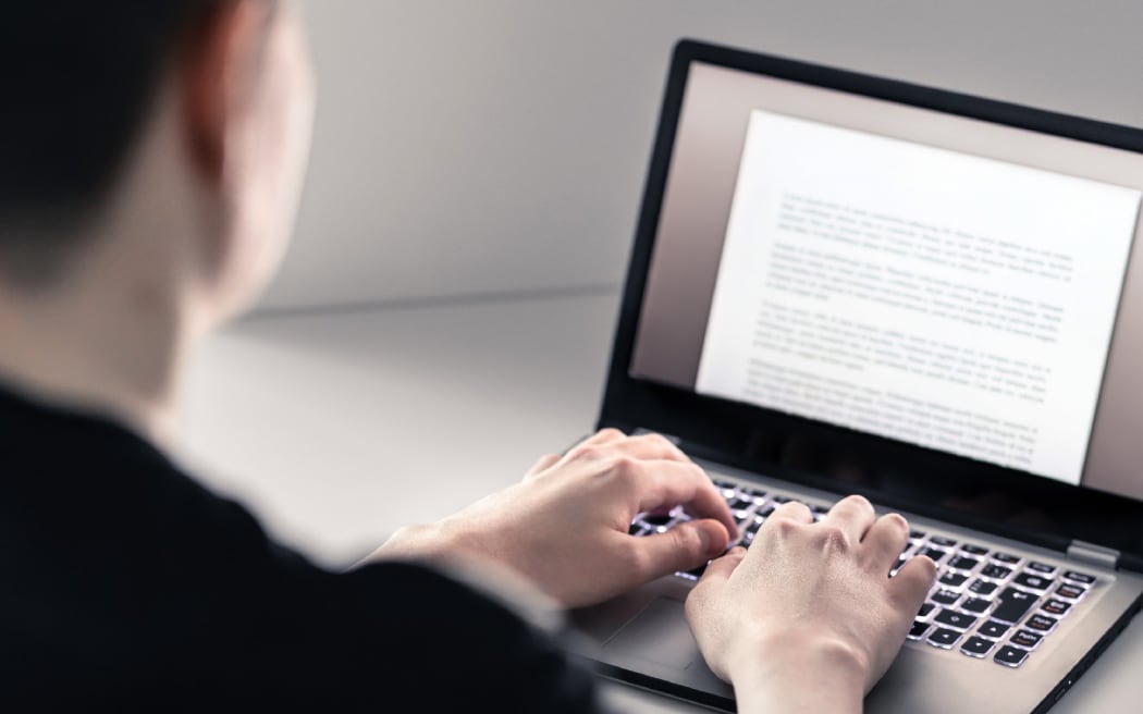 A man uses a laptop computer.