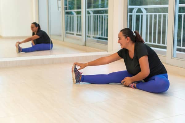 A woman stretching in a gym