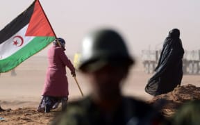 A Sahrawi woman holds a Polisario Front's flag during a 2016 ceremony to mark 40 years after the Front proclaimed the Sahrawi Arab Democratic Republic in the disputed territory of Western Sahara.