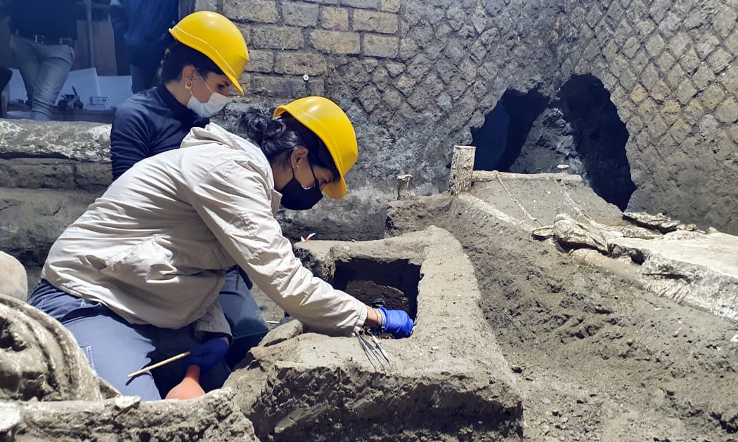 Archaeologists working in "The room of Slaves", an exceptionally well-preserved room for the slaves who worked in Villa Civita Giuliana in Pompeii.