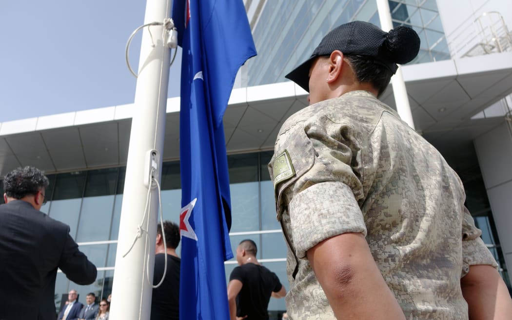 The New Zealand flag is raised for the first time outside the building housing New Zealand's expanded Consulate-General in Dubai