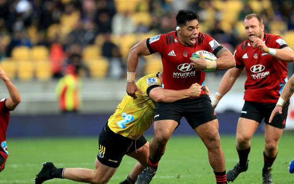 Crusaders Michael Alaalatoa is tackled by Hurricanes' Fraser Armstrong .