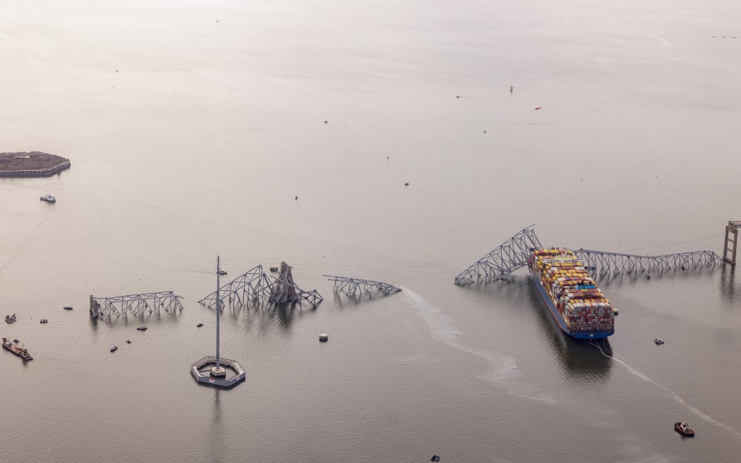 BALTIMORE, MARYLAND - MARCH 26: In an aerial view, cargo ship Dali is seen after running into and collapsing the Francis Scott Key Bridge on March 26, 2024 in Baltimore, Maryland. Rescuers are searching for at least seven people, authorities say, while two others have been pulled from the Patapsco River.   Tasos Katopodis/Getty Images/AFP (Photo by TASOS KATOPODIS / GETTY IMAGES NORTH AMERICA / Getty Images via AFP)