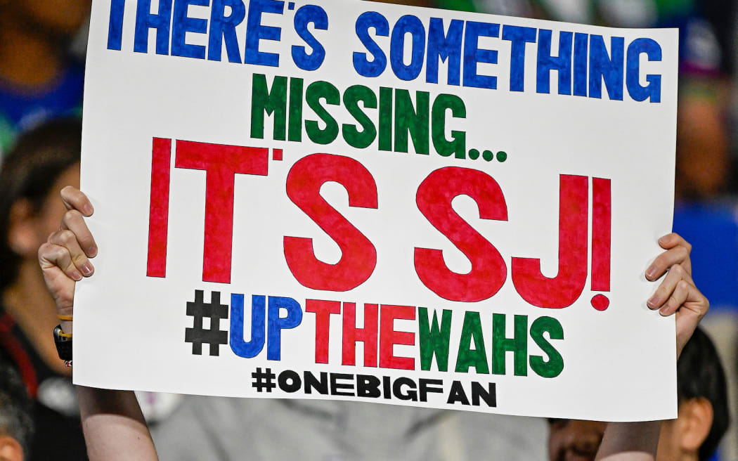 One NZ Warriors fans, crowd and supporters hold up signs to support the Warriors.
