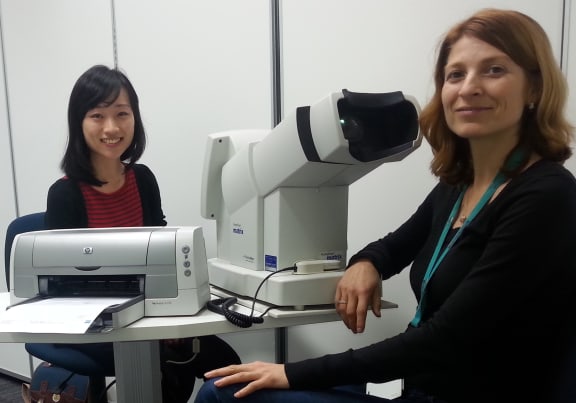 A photo of Lily Chang conducting an eye test on participant Rosica Petrova
