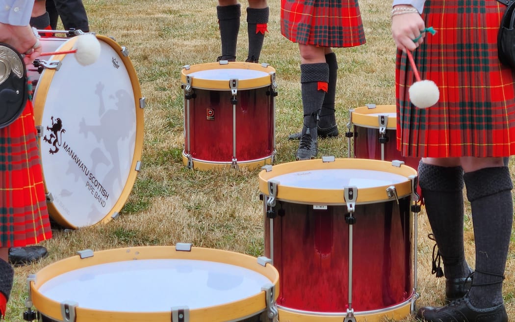 The drum corps of the Manawatū Scottish Pipe Band take a rest