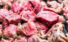 Close up pieces of chopped beef meet stewed in skillet