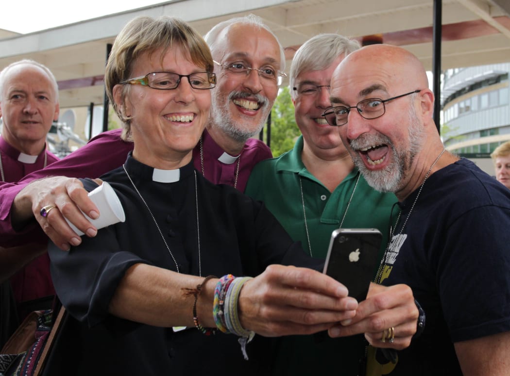 A member of the clergy takes a selfie after the vote to approve the creation of women bishops in the Church of England.