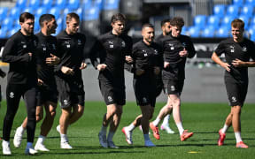 All Whites players warm up.
