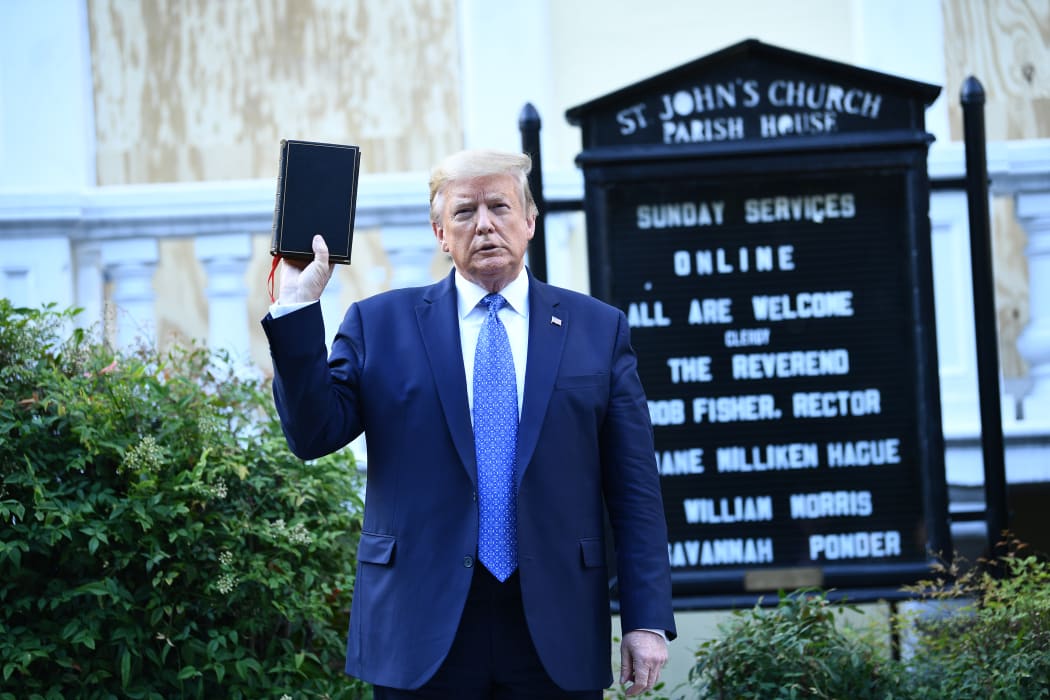 US President Donald Trump holds up a bible in front of St John's Episcopal church.