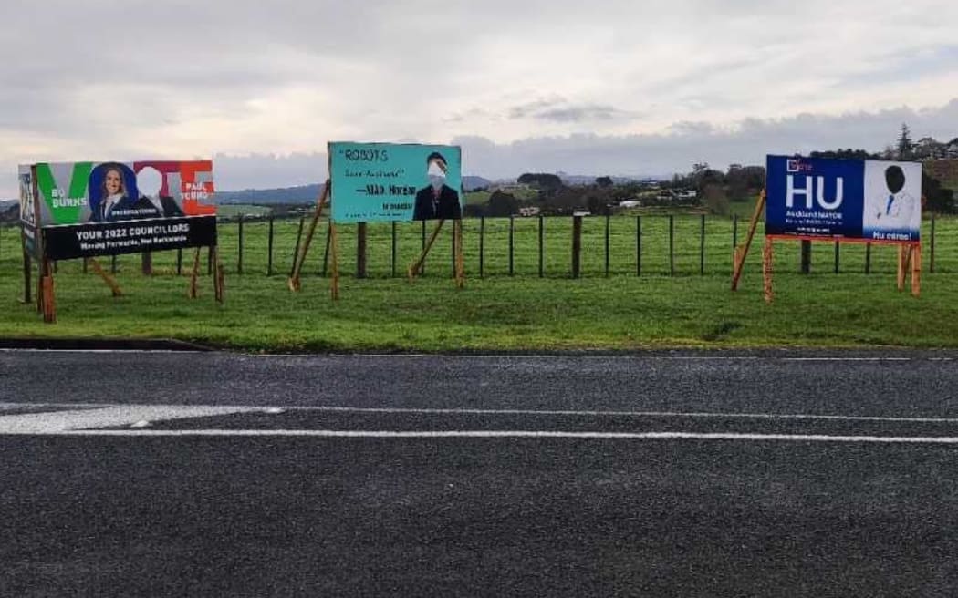 Four Auckland local body election candidates have seen their faces painted over or cut out of billboards.