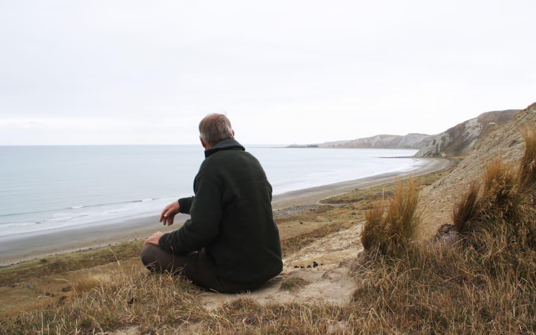 East Coast Protection Group member Rob Peter looks over the east coast, towards the Cape Cambell Lighthouse.