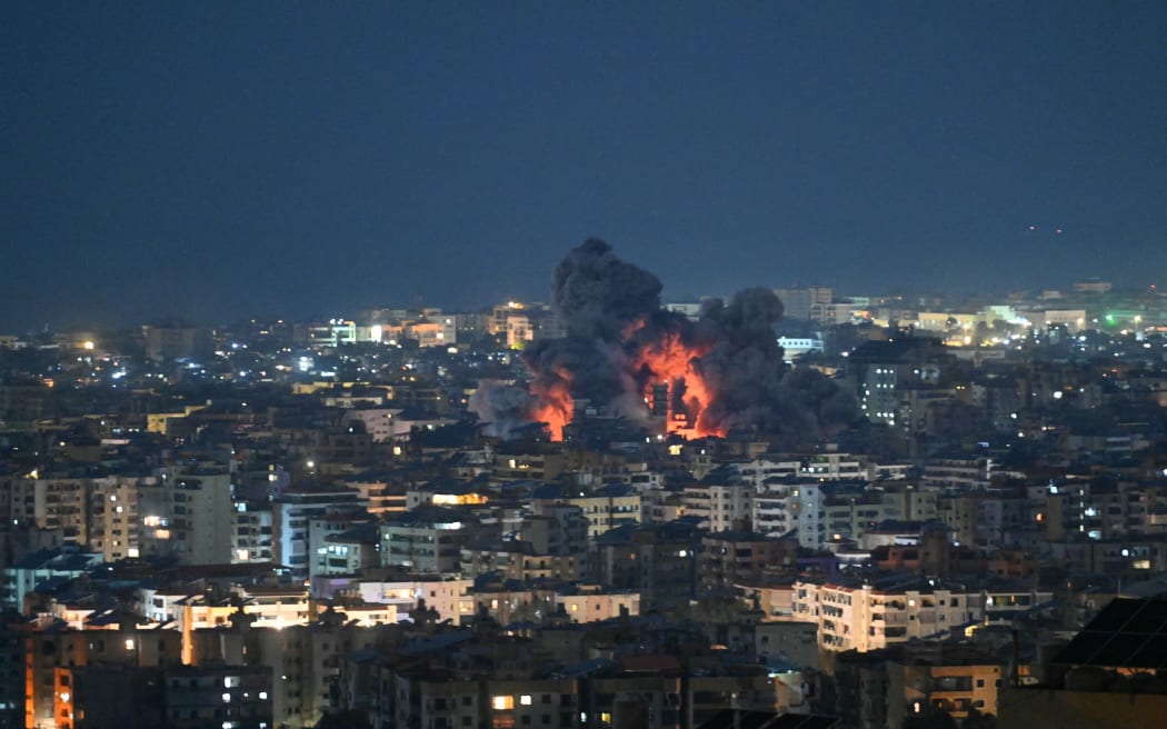 Fire blazes and black smoke rises from the site of an Israeli airstrike that targeted the office of the Hezbollah affiliated Al-Manar TV station in Beirut’s southern suburb of Haret Hreik on March 3, 2026. An Israeli strike hit the south Beirut office of Al-Manar TV, which is affiliated with Iran-backed militant group Hezbollah, the broadcaster said on March 3. Israel "targets the Al-Manar Channel building in the Haret Hreik area," Al-Manar wrote on Telegram, referring to a part of south Beirut. (Photo by FADEL itani / AFP)