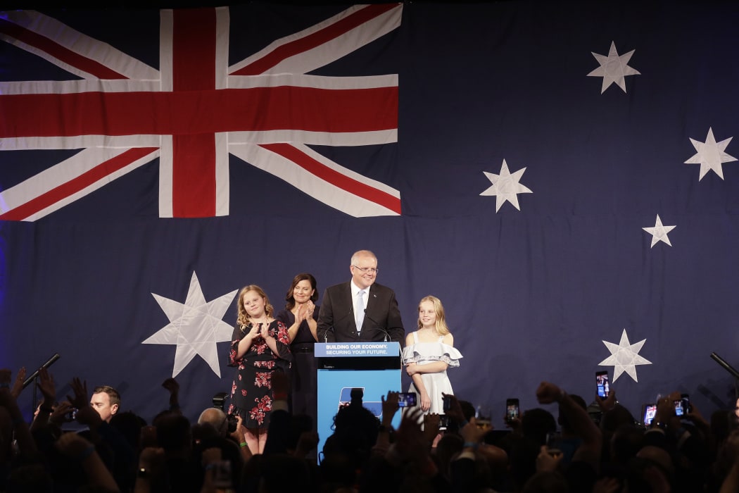 Australian Prime Minister Scott Morrison arrives to speak to party supporters flanked by his wife Jenny, and daughters Abbey, left, and Lily after his opponent Bill Shorten conceded defeat in the federal election.