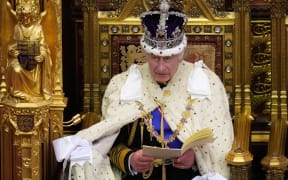 Britain's King Charles III, wearing the Imperial State Crown and the Robe of State, reads the King's speech from The Sovereign's Throne in the House of Lords chamber, during the State Opening of Parliament, at the Houses of Parliament, in London, on November 7, 2023. (Photo by Kirsty Wigglesworth / POOL / AFP)