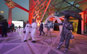 A handout picture provided by the Saudi Royal Palace on 18 April shows a mime actor standing behind a model vintage cinema camera at the entrance of the AMC cinema in the capital Riyadh.