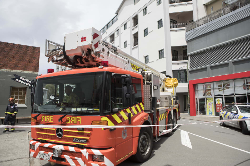 Emergency service outside Tennyson Apartments on Tennyson St, Wellington. The apartments have been evacuated because of structural damage.