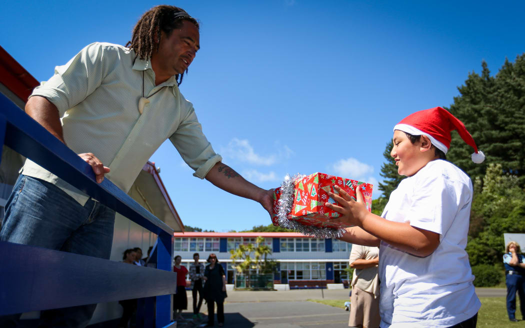 Taipana Hiroti-Teaia is given a present by deputy principal Lester Mohi