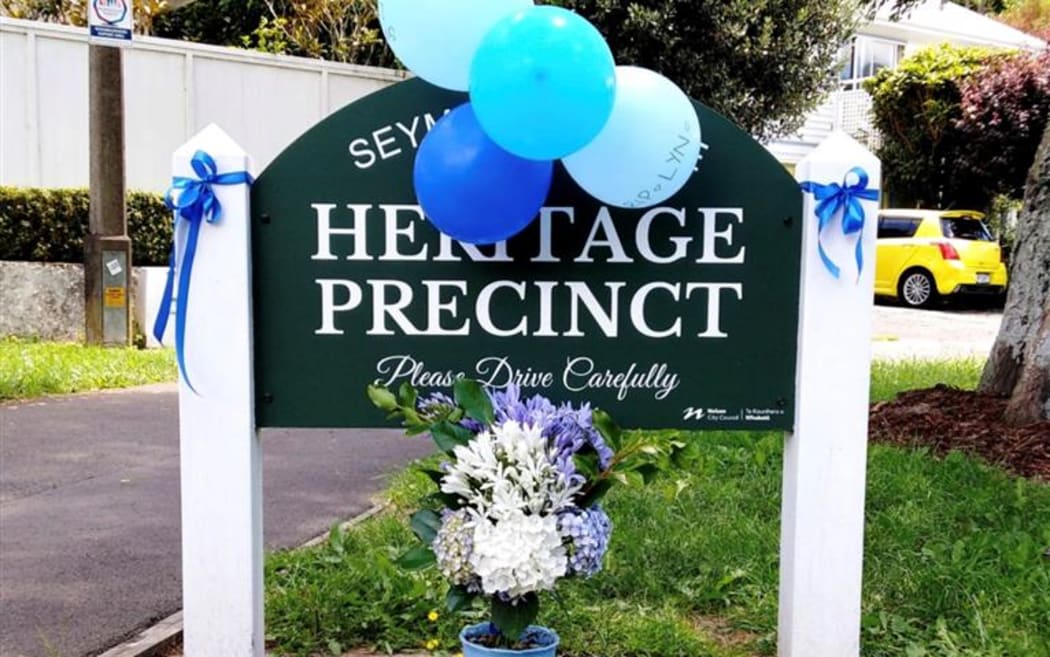 Andrea Warn made a bouquet of blue and white flowers and tied blue ribbons and balloons onto a street sign to honour slain police officer Lyn Fleming.