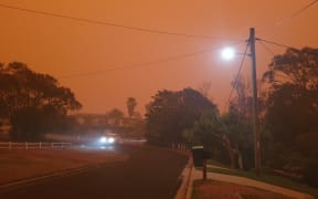 Tathra, New South Wales as bush fires blaze nearby.