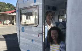 Houghton Valley principal Raewyn Watson and board chairperson Sarah Graydon with “Dotty,” the caravan the school is using for small-group work.