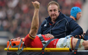 Wales captain Sam Warburton shows the Welsh spirit as he is stretchered away during a match against England in March.