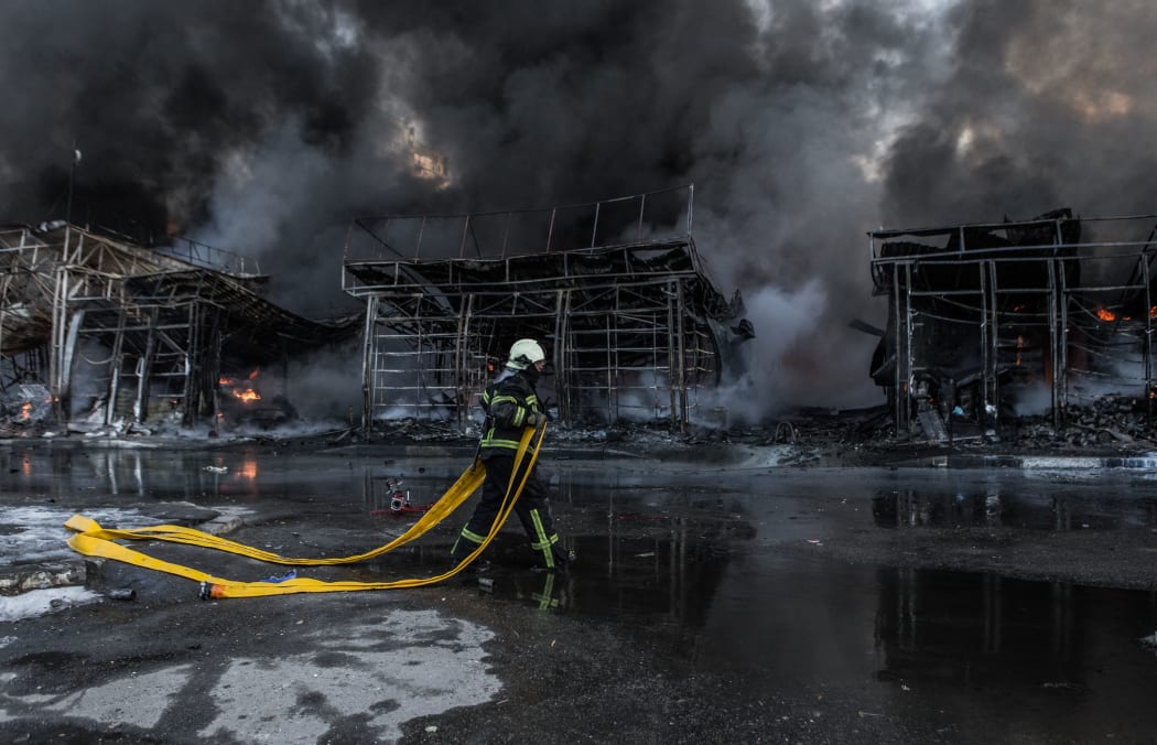KHARKIV, UKRAINE - MARCH 16: Firefighters try to extinguish a fire broke out at the Saltivka construction market, hit by 6 rounds of Russian heavy artillery in Kharkiv, Ukraine on March 16, 2022.