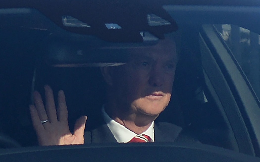 Manchester United's Dutch manager Louis van Gaal waves as he is driven away from Old Trafford stadium in Manchester, north west England, on May 15, 2016,