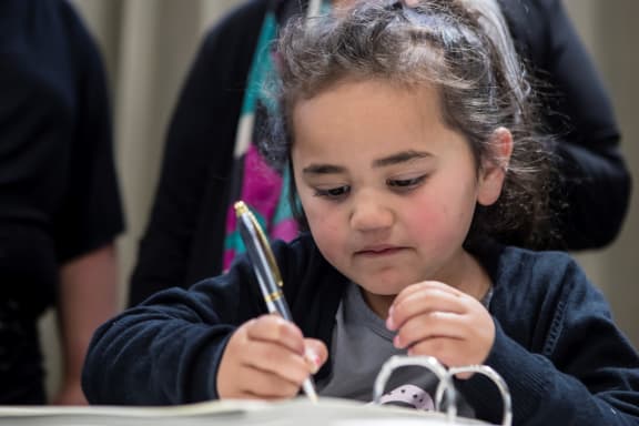 Te Awatea Olsen-Miller (4) signs the Ahuriri deed of settlement.