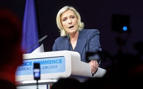 Former president of the French far-right Rassemblement National (RN) parliamentary group Marine Le Pen gives a speech during the results evening of the first round of the parliamentary elections in Henin-Beaumont, northern France, on June 30, 2024. A divided France is voting in high-stakes parliamentary elections that could see the anti-immigrant and eurosceptic party of Marine Le Pen sweep to power in a historic first. The candidates formally ended their frantic campaigns at midnight June 28, with political activity banned until the first round of voting. (Photo by FRANCOIS LO PRESTI / AFP)