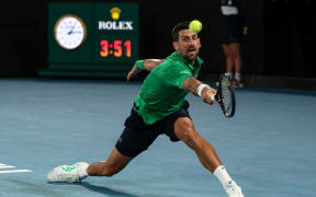 Serbia's Novak Djokovic hits a return to Italy's Jannik Sinner during their men's singles semi-final match on day thirteen of the Australian Open tennis tournament in Melbourne on January 31, 2026.