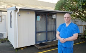 Dr Wim Ruelens outside the relocatable cabin at The Doctors on Desmond Road in Gisborne in June 2023, where sewage issues have caused major disruptions to the business. The cabin, usually used for possible Covid-19 cases, is being used as a temporary clinic.