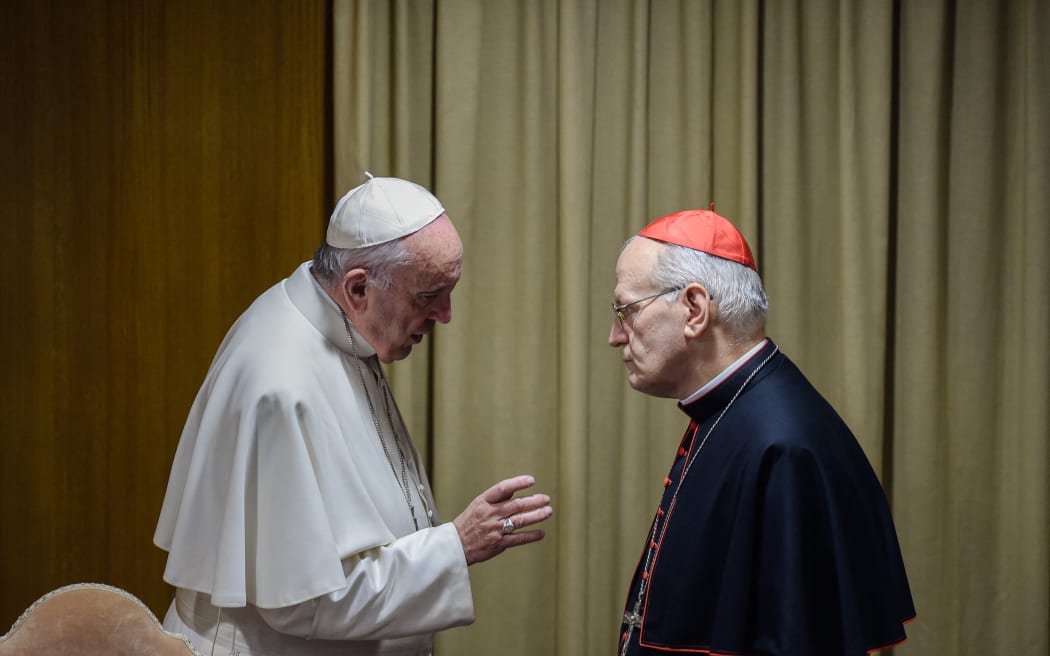 Pope Francis (L) speaks with Hungarian cardinal Peter Erdo during the morning session of the last day of the Synod on the Family at the Vatican on October 24, 2015. Pontiff on October 4 defended marriage and heterosexual couples as he opened a synod on the family overshadowed by a challenge to Vatican. Pope Francis accelerated his streamlining of the Vatican bureaucracy by announcing plans to create a new ministry which will increase the role of lay believers in the Church. The Pontiff made the announcement to an afternoon session of the synod, which is due to conclude at the weekend after three weeks of often heated discussions on issues such as divorce, homosexuality and cohabitation. AFP PHOTO / ANDREAS SOLARO (Photo by ANDREAS SOLARO / AFP)