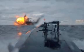 A Ukrainian sea drone shows the Dashan, a sanctioned oil tanker, being struck by another sea drone in the Black Sea on Tuesday, December 9, in a still from a video shared by Ukraine's Security Service.