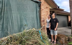 East Tamaki residents Ramil Casas and his wife Nema Rose saw significant damage to their rental property.  
Ramil Casas says he was only narrowly missed by the tree branches which smashed through his window just before 9pm on Sunday. He says he was working in the living room when the wind started howling, he went near the window hoping to check, and that was when the branches cut through the glass.  He says he feels lucky that they're now safe "It's like surreal, we can't believe that we survived the tornado". Ramil Cases says their roof was also damaged, and meanwhile tiles from a neighbour's roof had smashed into his flatmates' car.